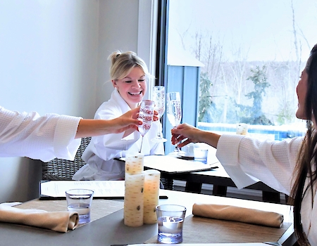 Women toasting champagne in spa robes at The Preserve Resort & Spa