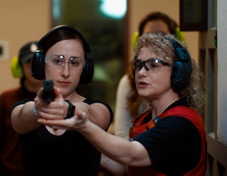 Woman receiving gun training at The Range