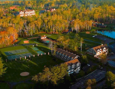 Aerial view of The Preserve Sporting Club & Residences surrounded by lush Rhode Island landscape.